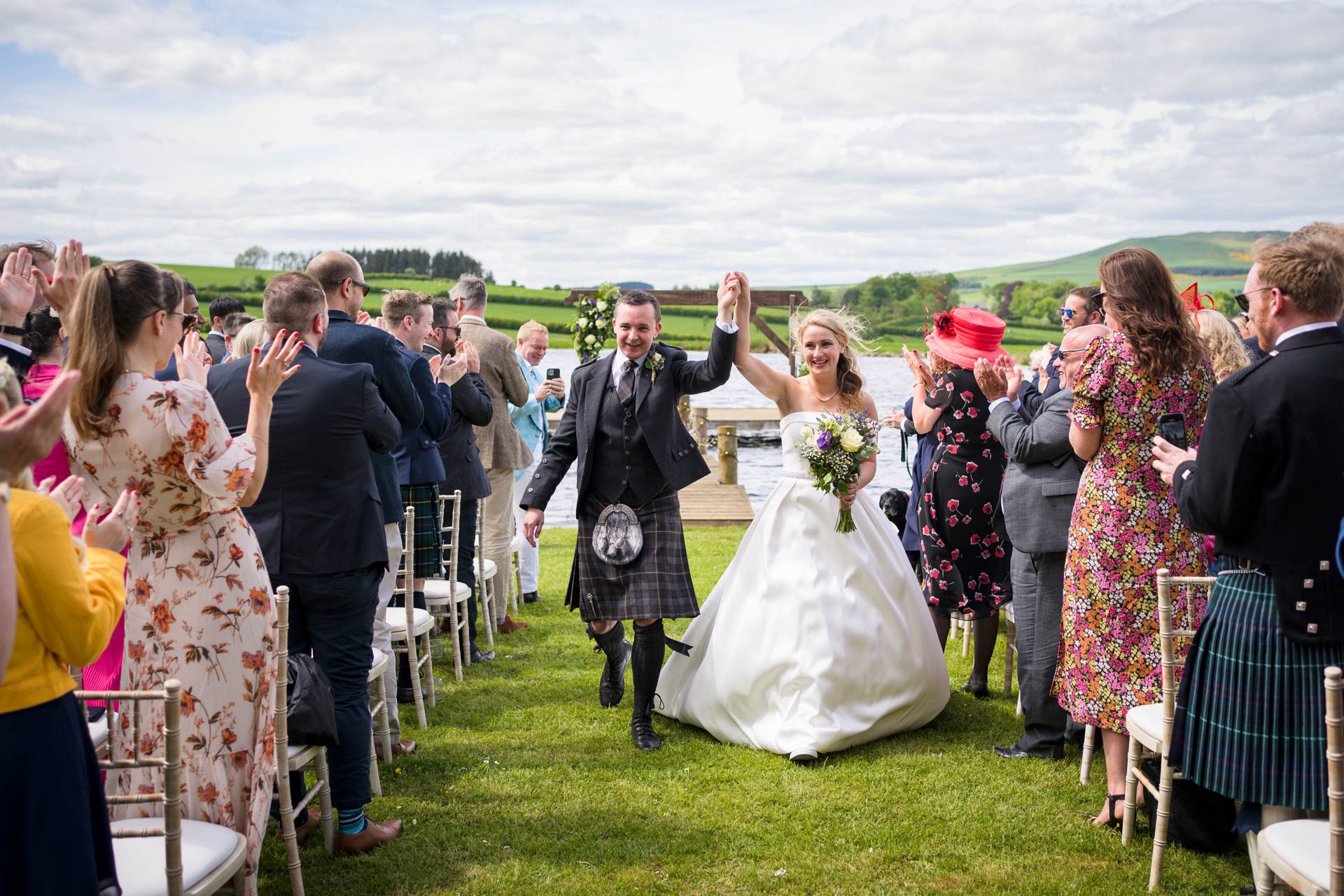 Hollie and Colin processing down the aisle at the end of their wedding ceremony