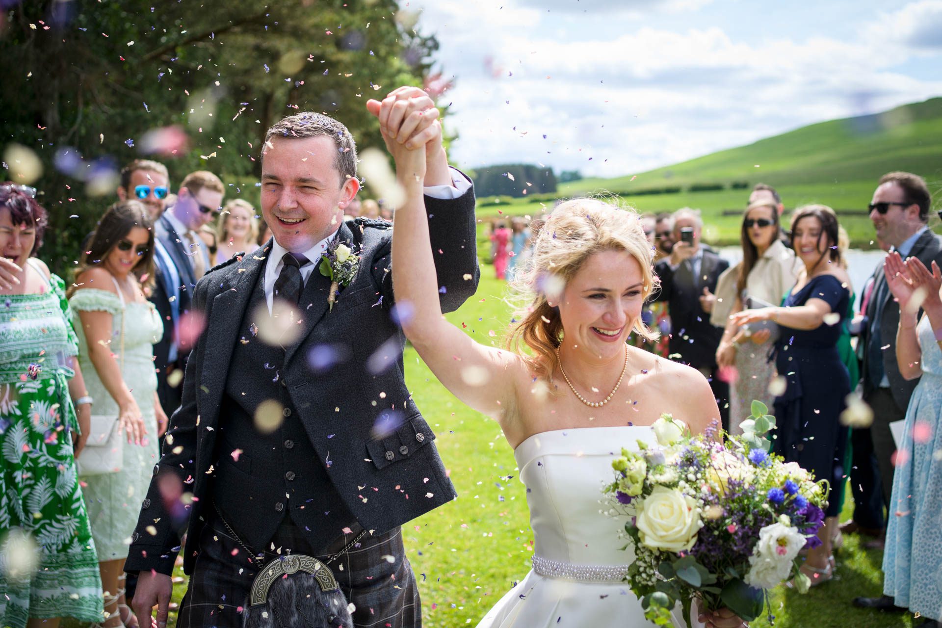 Wedding confetti being thrown for the bride and groom