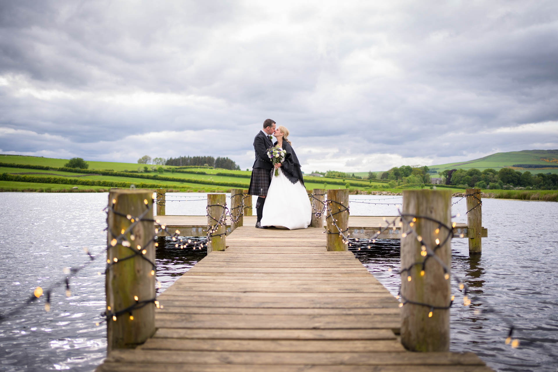 Wedding portrait of Hollie and Colin on the lake's jetty at their Scottish Borders wedding