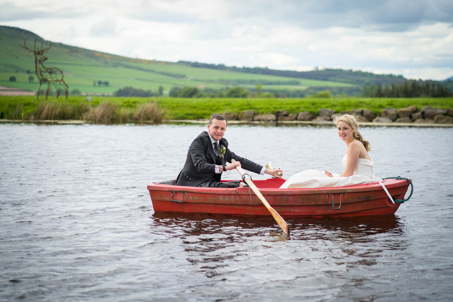 Hollie and Colin in a rowing boat at their Scottish Borders wedding