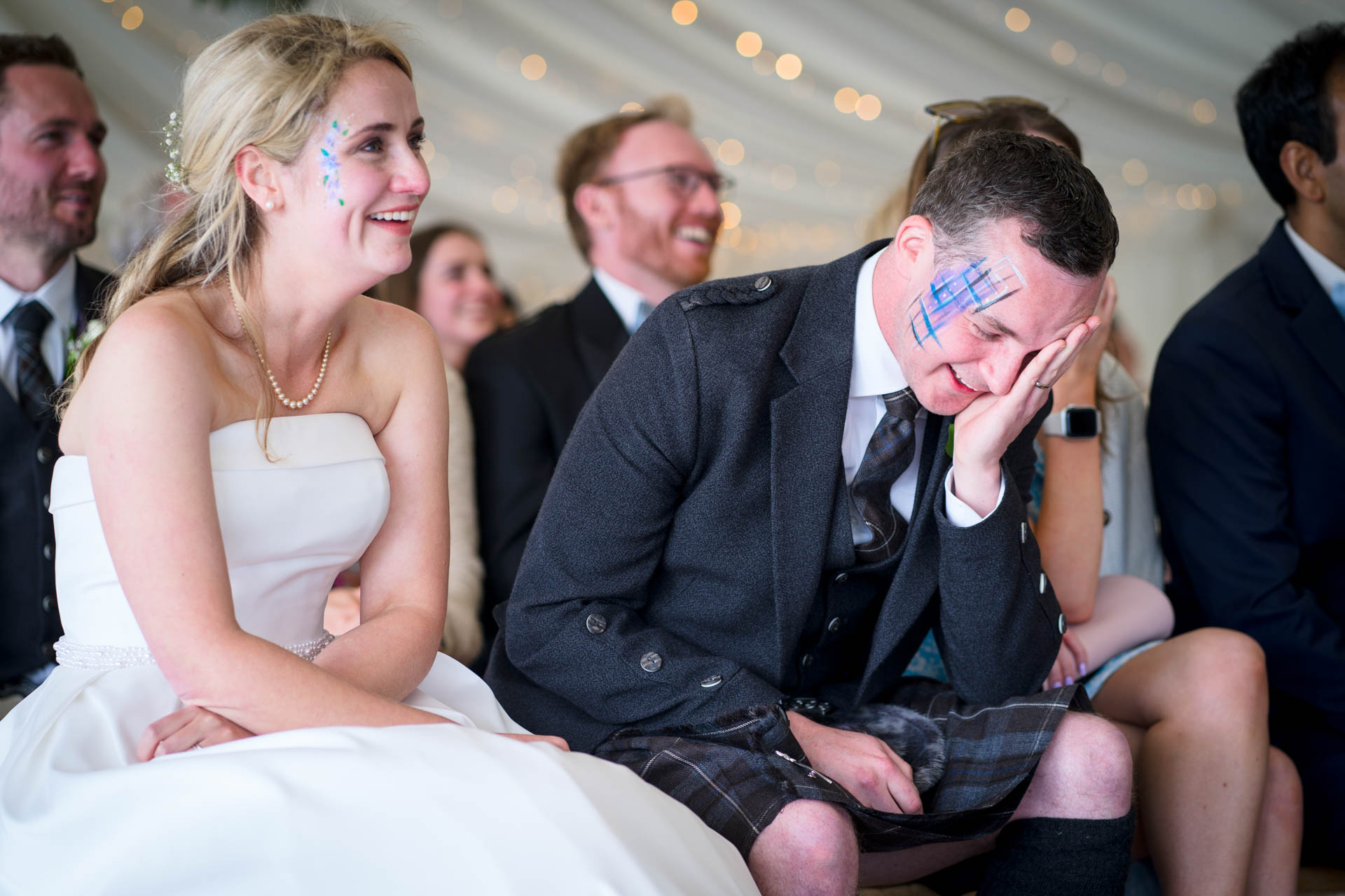 Groom reacting to best man's wedding speech