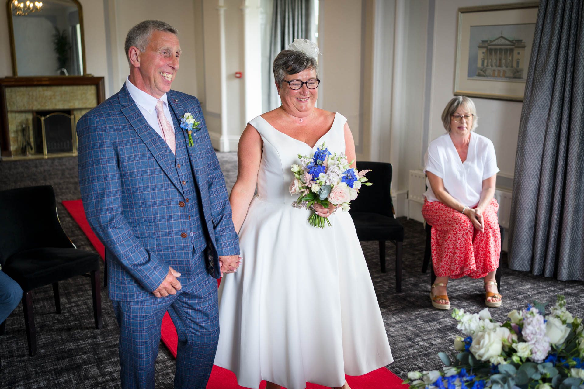 Bride and groom holding hands during their Low Wood Bay Resort Wedding Ceremony