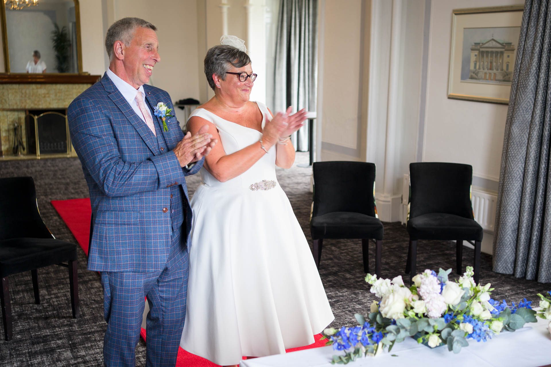 Bride and groom applaud their guest that made the reading 