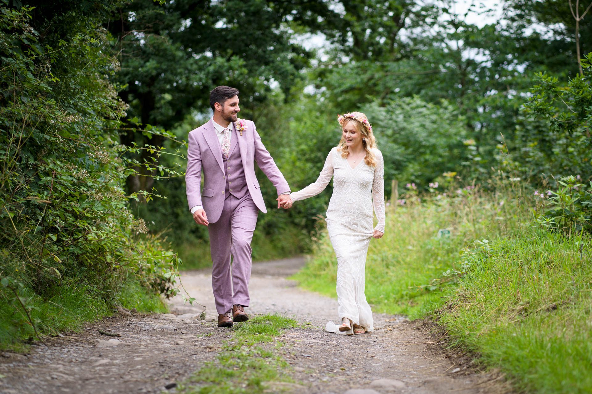 Wedding portrait at Ribble Valley wedding - bride and groom laughing as they walk towards camera