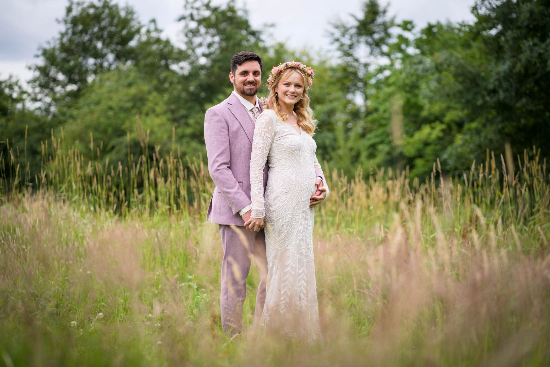 Wedding portrait at Ribble Valley wedding - bride and groom hugging in field of long grass